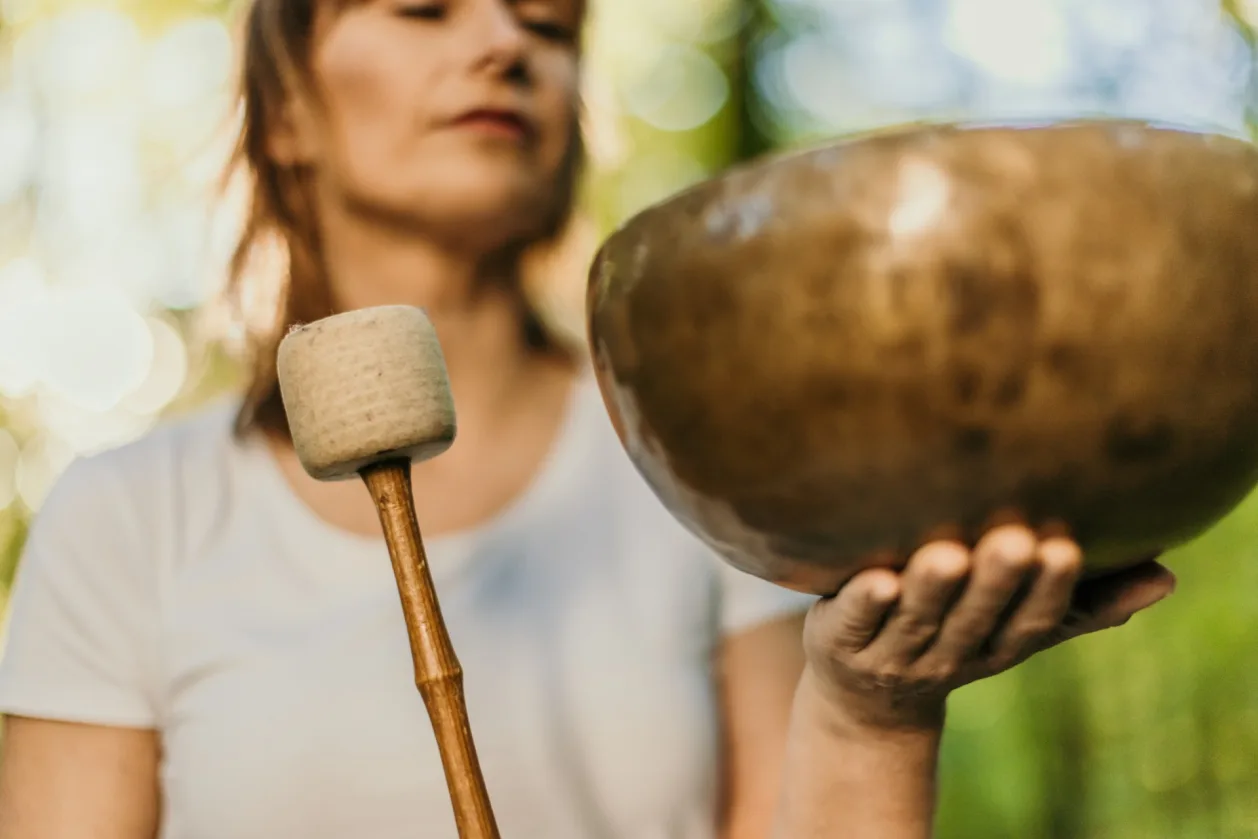 close-up-of-woman-using-a-rin-gong-sound-therapy-forest-essential-wellness-trend